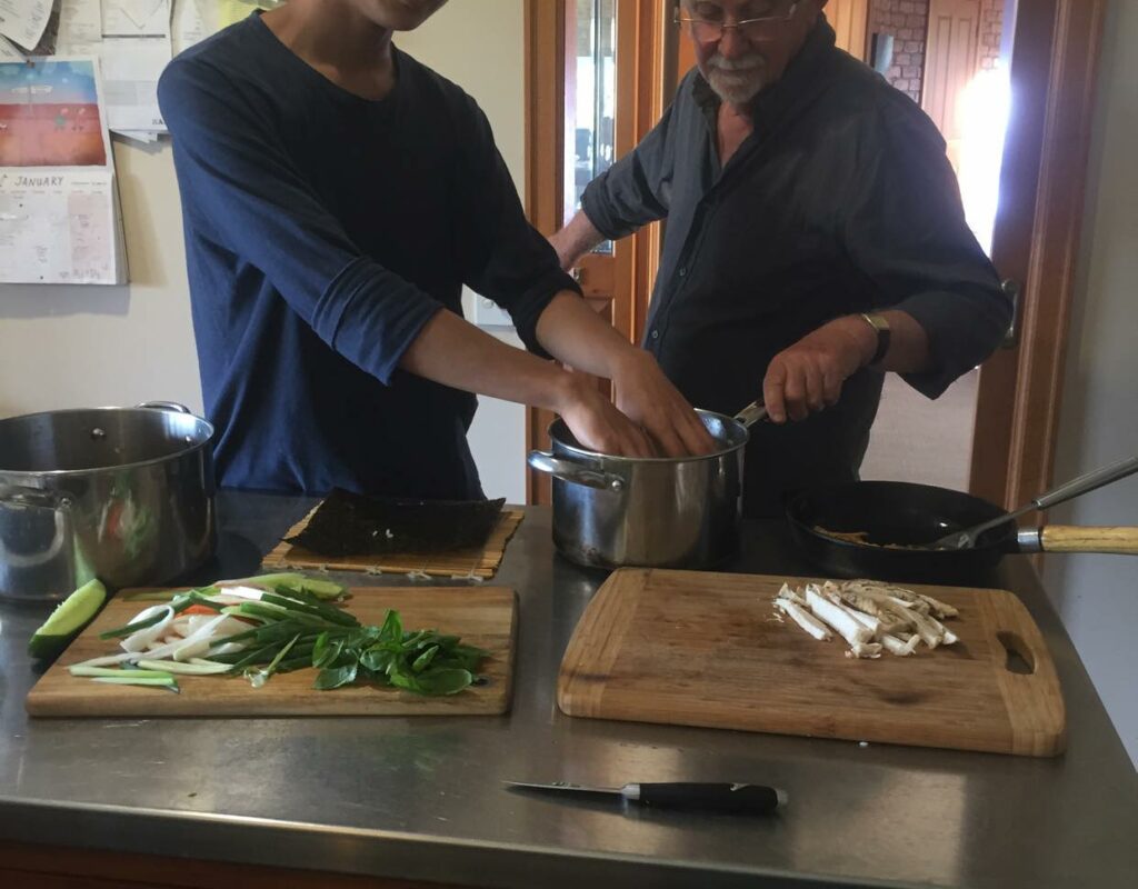 Ray and a wwoofer preparing dinner